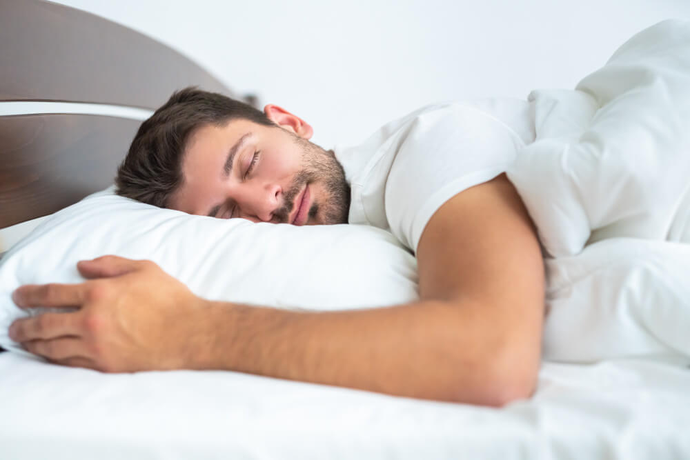 Uomo che dorme su materasso traspirante